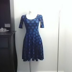 Blue and black dress with cube shapes and low slee